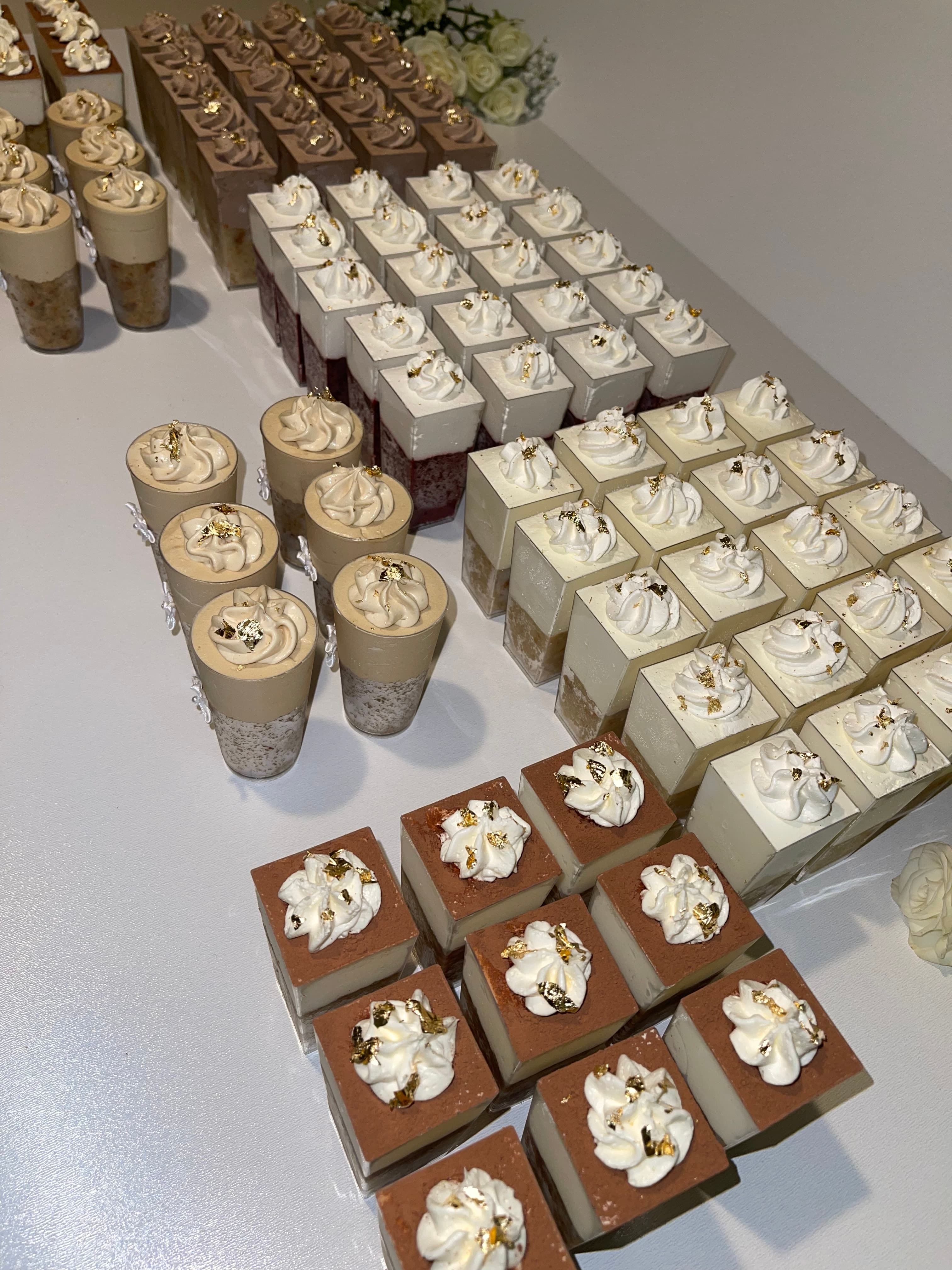 Boxed assortment of chocolate and vanilla mini dessert cups with gold leaf, packed for Cart & Co. Catering Pickup Menu pickup
